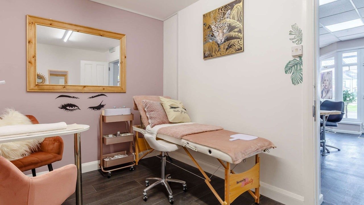 The beauty room with a treatment bed and a large mirror